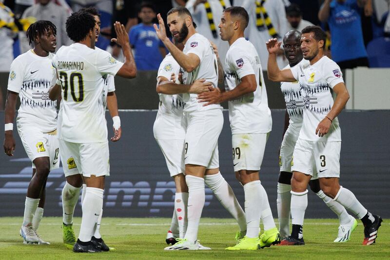 Ittihad's French forward Karim Benzema (C) celebrates with teammates after scoring his team's second goal during the 2023 Arab Club Champions Cup group A football match between Tunisia's Esperance de Tunis and Saudi Arabia's Al-Ittihad at the King Fahd Stadium in Taif on July 27, 2023.  (Photo by AFP)