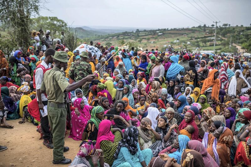 Ethiopian refugee women wait to receive non-food items distributed by the Kenyan Red Cross at the newly built Somare refugee camp in Moyale, Kenya's border town with Ethiopia, on March 19, 2018.
Thousands have fled to Kenya from the Ethiopian border town of Moyale after the shooting of nine civilians by troops, the Kenyan Red Cross said last week. Ethiopian state media said soldiers on March 10 shot nine civilians near the town after mistaking them for members of the banned Oromo Liberation Front (OLF) who were trying to sneak into the country. / AFP PHOTO / Brian OTIENO