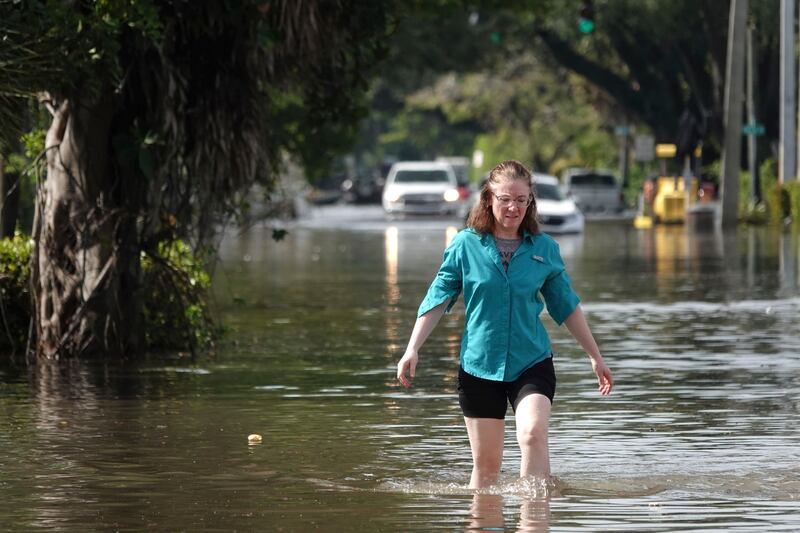 A woman wades through floodwaters in a Fort Lauderdale neighbourhood as the city keeps a wary on a forecast calling for more rain. AP