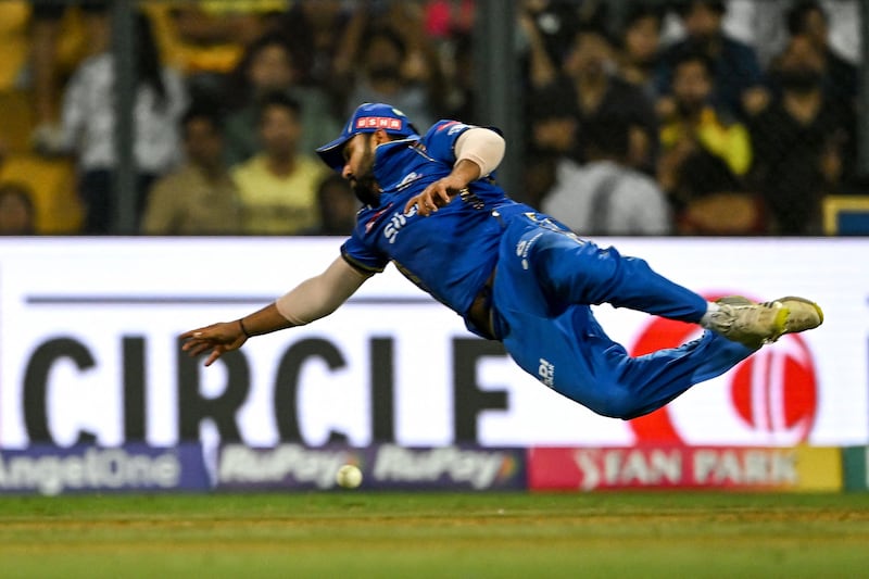 Mumbai Indians' Rohit Sharma dives to field the ball. AFP