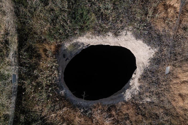 A dramatic view of a gaping sinkhole into which arable land has collapsed in Karapinar.
