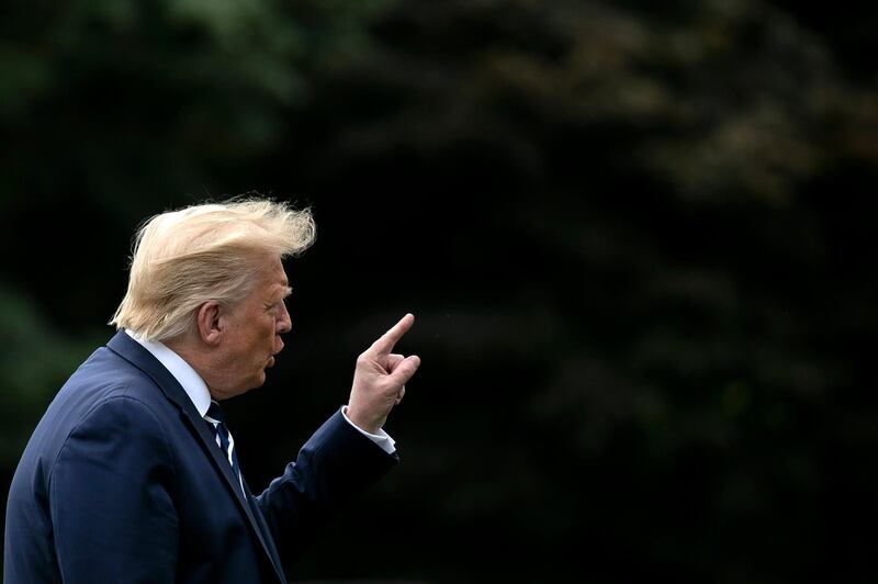 epa08608299 US President Donald J. Trump gestures as he walks on the South Lawn of the White House after arriving on Marine One in Washington, DC, USA, 16 August 2020.  EPA/Stefani Reynolds / POOL