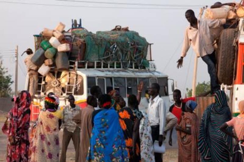 Southern Sudanese arrive by bus in Bentiu after a three-day drive from Khartoum on January 9, 2011, on the first day of a week-long independence referendum expected to lead to the partition of Africa's largest nation and the creation of the world's 193rd UN member state. Tens of thousands of families are travelling back from the north as many believe the referendum for independence will split Africa’s largest country in two. AFP PHOTO/Yasuyoshi Chiba