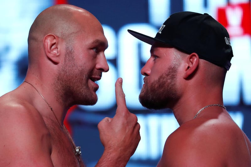 Tyson Fury and Tom Schwarz during the weigh in. REUTERS