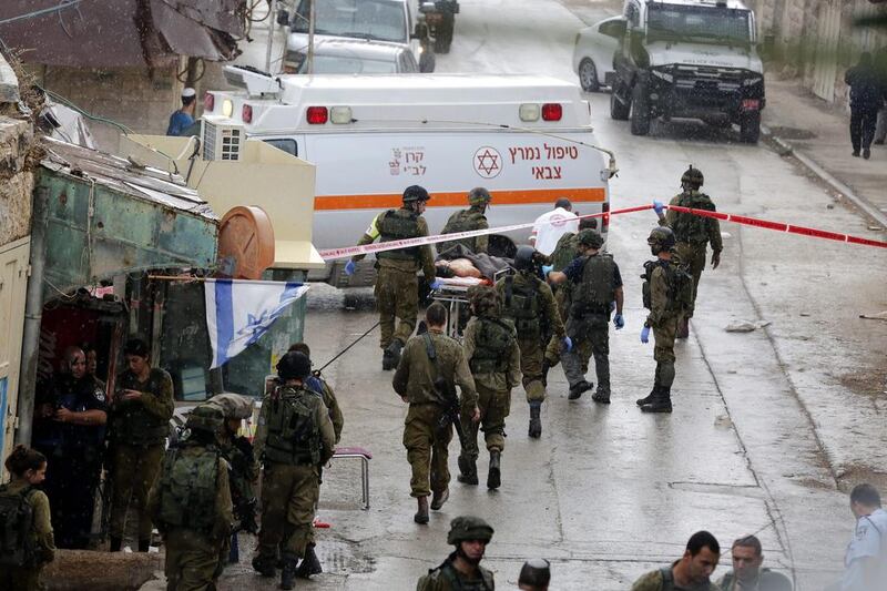 Palestinian Saad Atrazh is carried to an ambulance after being shot by Israeli soldiers near the Ibrahimi Mosque in the Old City of Hebron in the West Bank on October 26, 2015. Abed Al Hashlamoun / EPA