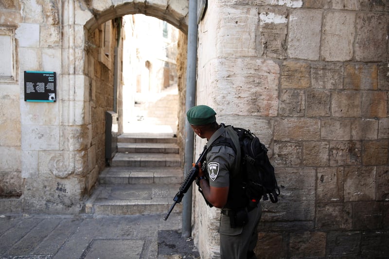 An Israeli border police officer guards next to an entrance leading to the compound known to Muslims as Noble Sanctuary and to Jews as Temple Mount, in Jerusalem's. Ammar Awad / Reuters