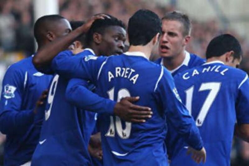 The Everton players celebrate with the match winner Louis Saha, second left.