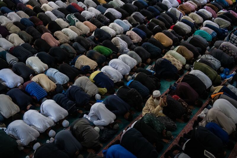Men perform morning prayers at East London Mosque. Getty