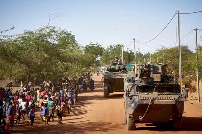 (FILES) In this file photo taken on November 14, 2019 soldiers of the French Army patrols the village Gorom Gorom in Armoured Personnel Carriers during the Barkhane operation in northern Burkina Faso  Four French officers deployed in the Sahel region as part of the Barkhane operation have tested positive for the COVID-19 disease (novel coronavirus), the French Armed Forces announced on April 2, 2020. / AFP / MICHELE CATTANI
