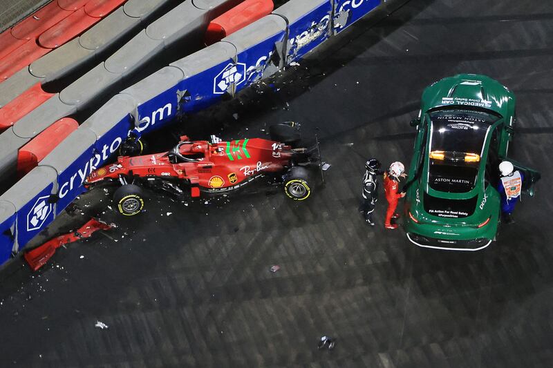 Ferrari's Charles Leclerc stands at the safety car after crashing during the second practice session of the Saudi Arabian Grand Prix at the Jeddah Corniche Circuit. AFP