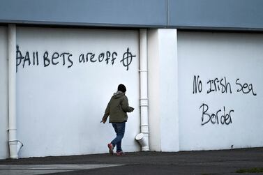 FILE PHOTO: Loyalist graffiti is seen with messages against the Brexit border checks in relation to the Northern Ireland protocol at the harbour in Larne, Northern Ireland February 12, 2021.  REUTERS / Clodagh Kilcoyne /  / File Photo