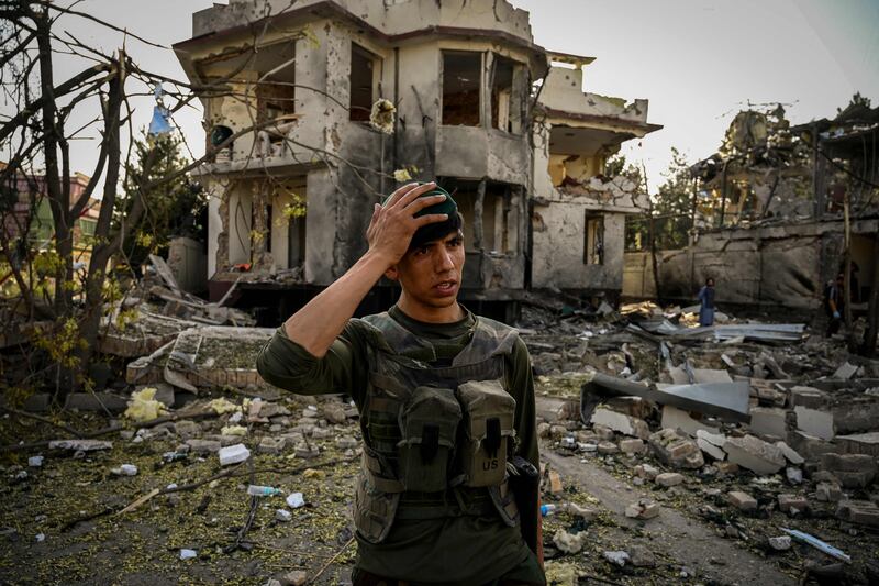 A member of the Afghan security forces at the site of a car bomb explosion in Kabul.