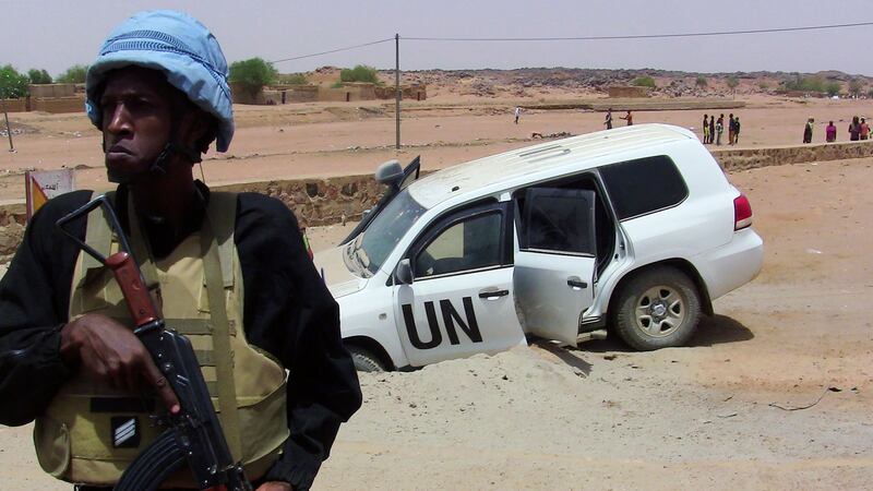 A Minusma soldier stands guard near a UN vehicle that drove over an explosive device in northern Mali in June last year. AFP