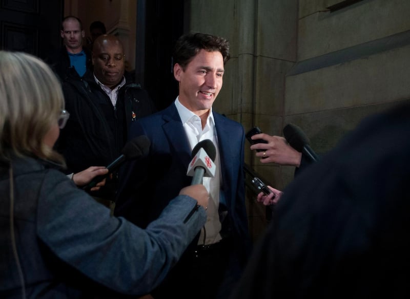 Prime Minister Justin Trudeau leaves the Office of the Prime Minister and Privy Council after an agreement was reached in the NAFTA negotiations in Ottawa, Ontario, Sunday, Sept. 30, 2018. The U.S. and Canada reached the basis of a free trade deal Sunday night, a senior Canadian government official said. (Justin Tang/The Canadian Press via AP)