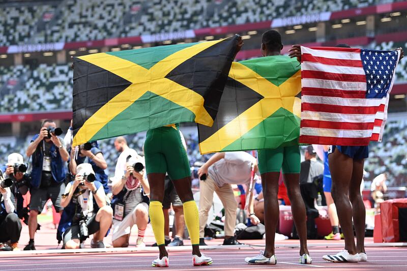 Gold medallist Jamaica's Hansle Parchment, centre, silver medallist Grant Holloway of USA and Jamaica's bronze medallist Ronald Levy.