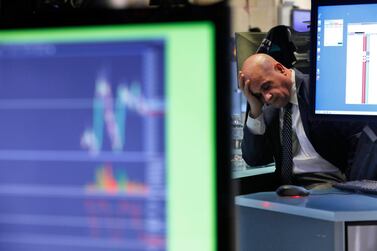 A specialist rests his head in his hand as he works on the floor of the NYSE as traders worry that the spreading coronavirus will threaten global economic growth. AP Photo