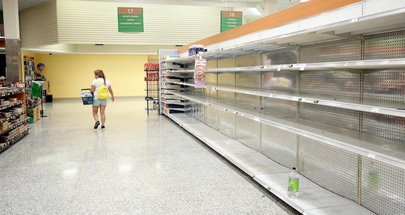 A shopper walks past empty shelves at a supermarket as Hurricane Irma makes landfall in Kissimmee, Florida. Gregg Newton / Reuters
