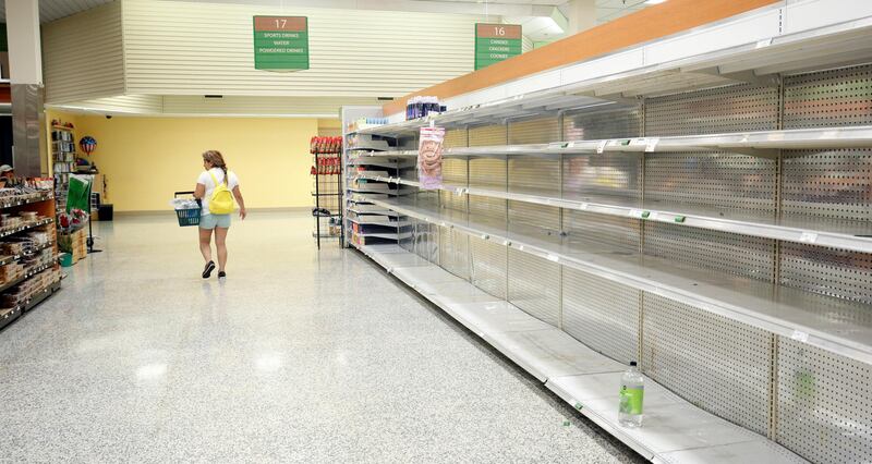 A shopper walks past empty shelves at a supermarket as Hurricane Irma makes landfall in Kissimmee, Florida. Gregg Newton / Reuters