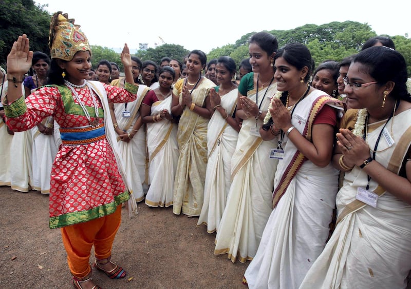 Indian students pose for a photograph as they celebrate the Onam Festival at a college campus in Channai on August 27, 2015. AFP PHOTO / STR (Photo by STRDEL / AFP)