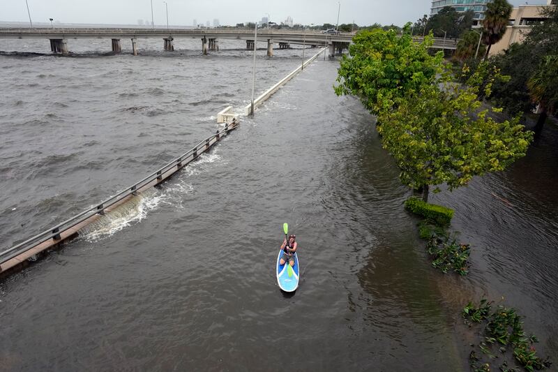 Floodwaters caused by Hurricane Idalia pour over the sea wall along Old Tampa Bay. AP