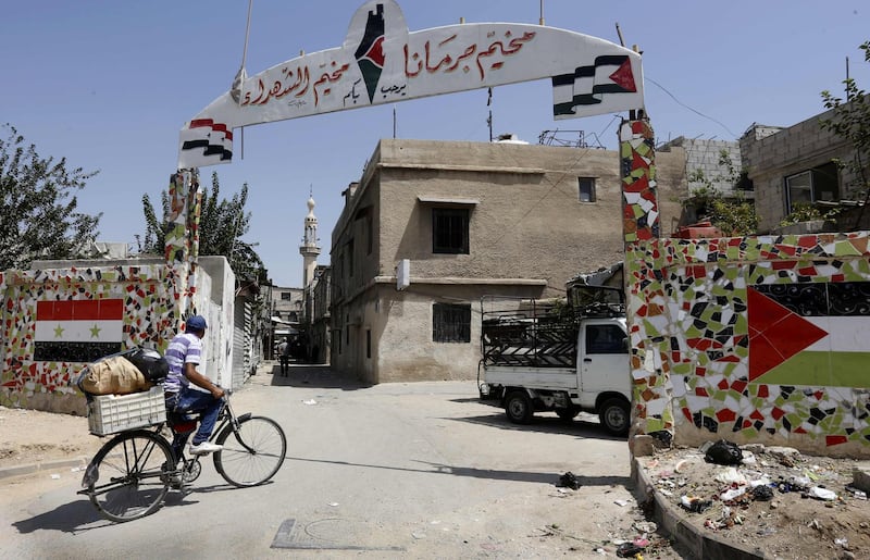 A man riding his bicycle enters the Jaramana Palestinian refugee camp in the Syrian capital Damascus. AFP