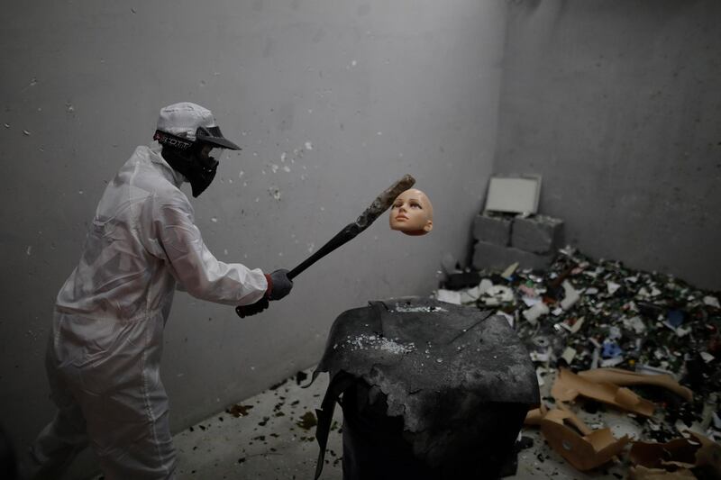 A consumer Xie Hanchen, smashes a head of mannequin in the Anger Room 'Smash' to release stress in Beijing, China. The anger room, which opened in September 2018, caters its business operations to help consumers release stress.  EPA