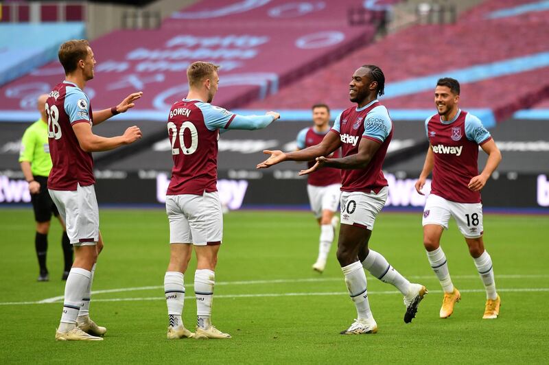LONDON, ENGLAND - OCTOBER 24: Michail Antonio of West Ham United  celebrates with his team after scoring his team's first goal  during the Premier League match between West Ham United and Manchester City at London Stadium on October 24, 2020 in London, England. Sporting stadiums around the UK remain under strict restrictions due to the Coronavirus Pandemic as Government social distancing laws prohibit fans inside venues resulting in games being played behind closed doors. (Photo by Justin Tallis - Pool/Getty Images)