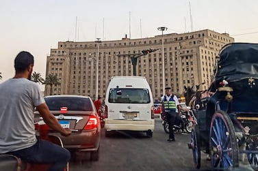 A policeman stops traffic traversing the roundabout in the Egyptian capital Cairo's central Tahrir Square on September 21, 2019. AFP