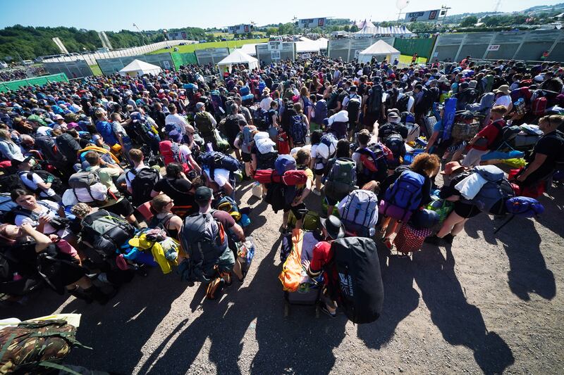 Thousands of people queue in the sunshine. Reuters