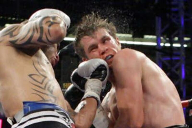 Yuri Foreman, right, is hit by Miguel Cotto during the seventh round of their WBA Super Welterweight title match.