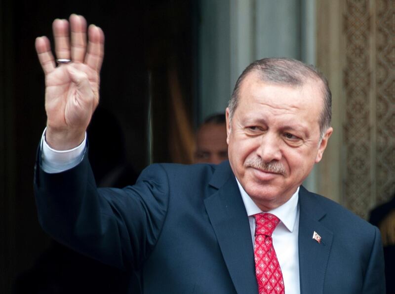 Turkish President Recep Tayyip Erdogan waves as he arrives at the Presidential Palace in Carthage, outside Tunis, Tunisia, Wednesday, Dec. 27, 2017. Syria's peace efforts cannot include President Bashar Assad, Turkey's leader said Wednesday, calling him a "terrorist." (AP Photo/Hassene Dridi)