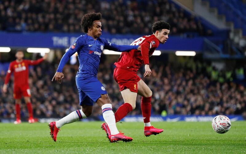 Liverpool's Curtis Jones, right, defends the ball from Chelsea's Willian. Reuters