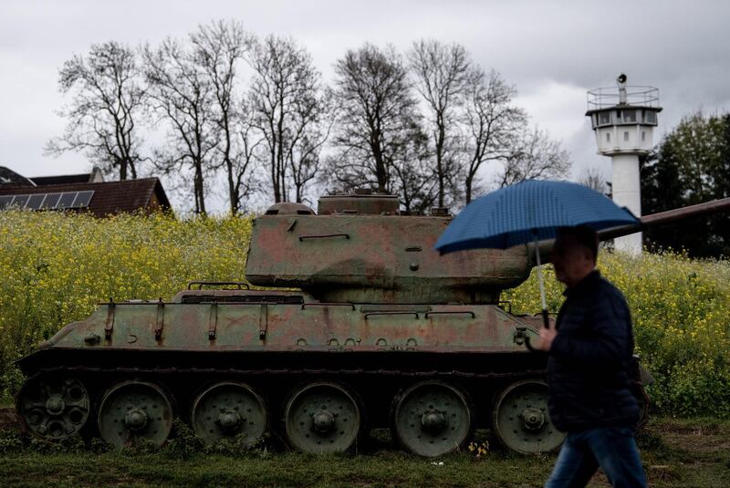 A visitor pass by a T-34 battle tank at former east German-west German borderline, part of German museum in Moedlareuth, Germany.  EPA