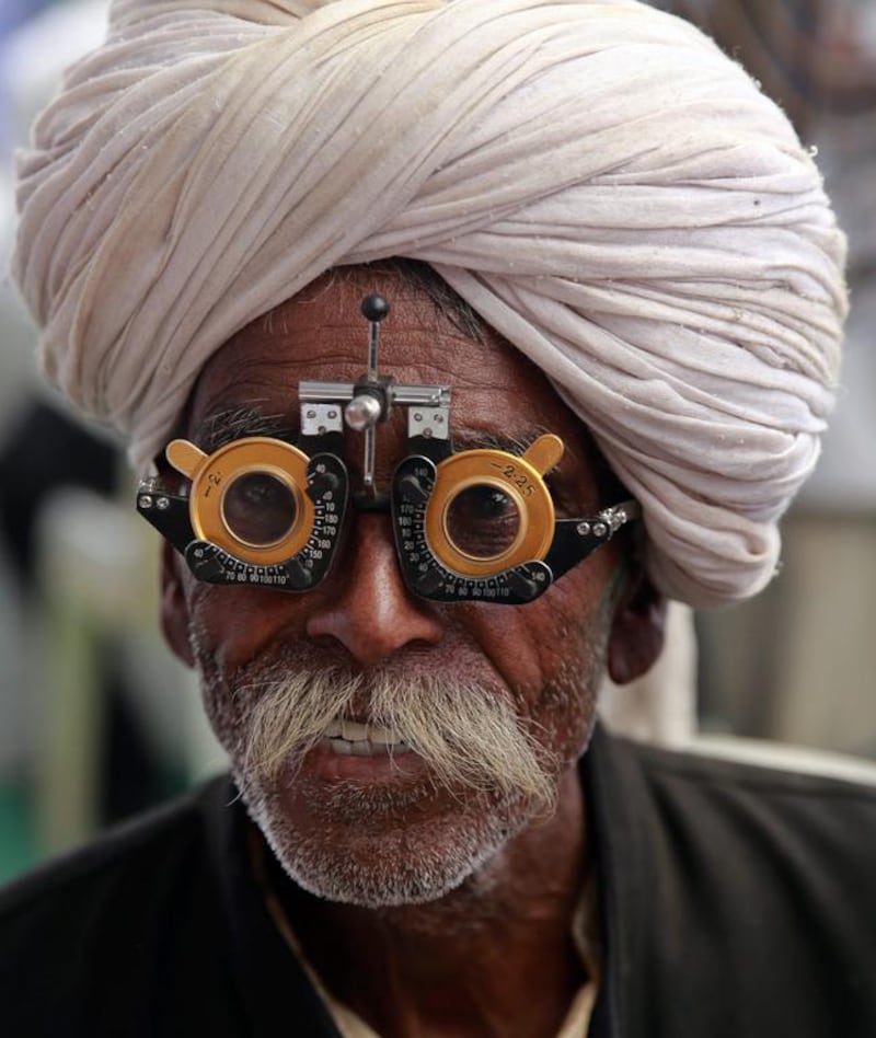 An Indian man gets his eyes examined at a free medical camp held to mark the anniversary of Bhim Rao Ambedkar's death in Mumbai, India. Rafiq Maqbool/AP Photo
