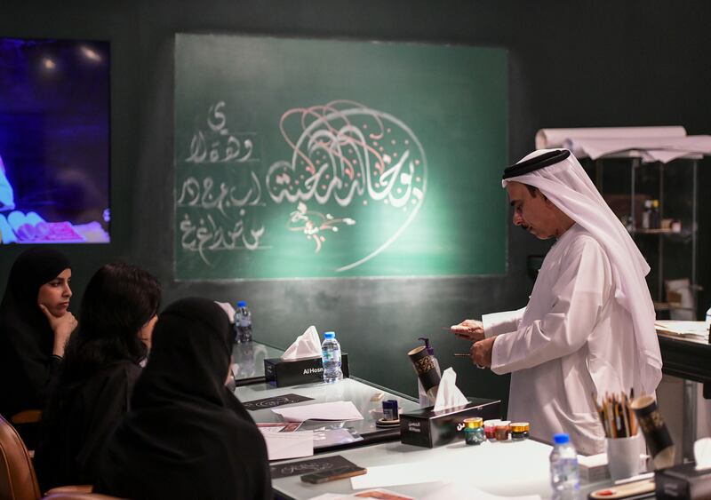 Mohammed Mandi teaches traditional calligraphy to students at the Cultural Foundation in Abu Dhabi. Khushnum Bhandari / The National
