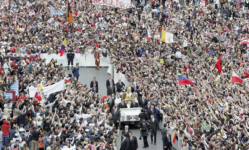 VATICAN CITY, VATICAN - APRIL 24:  Pope Benedict XVI waves to the masses from the Popemobile after leading his inaugural mass in Saint Peter's Square April 24, 2005 in Vatican City. Hundreds of thousands of pilgrims attended the mass led by the 265th Pope of the Roman Catholic Church.  (Photo by Mario Tama/Getty Images)