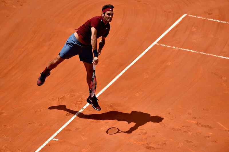 Roger Federer of Switzerland serves in his match against Dominic Thiem of Austria during their match at the Italian Open. Dennis Grombkowski / Getty Images