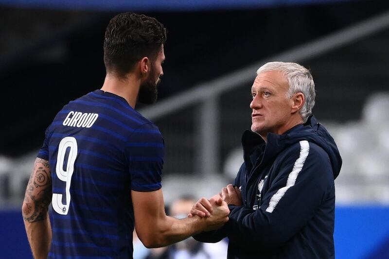 Olivier Giroud speaks with France's coach Didier Deschamps as he leaves the pitch. AFP