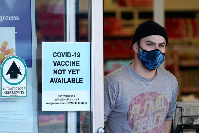 A customer walks out of a Walgreen's pharmacy store in Seattle, Washington, USA. AP Photo