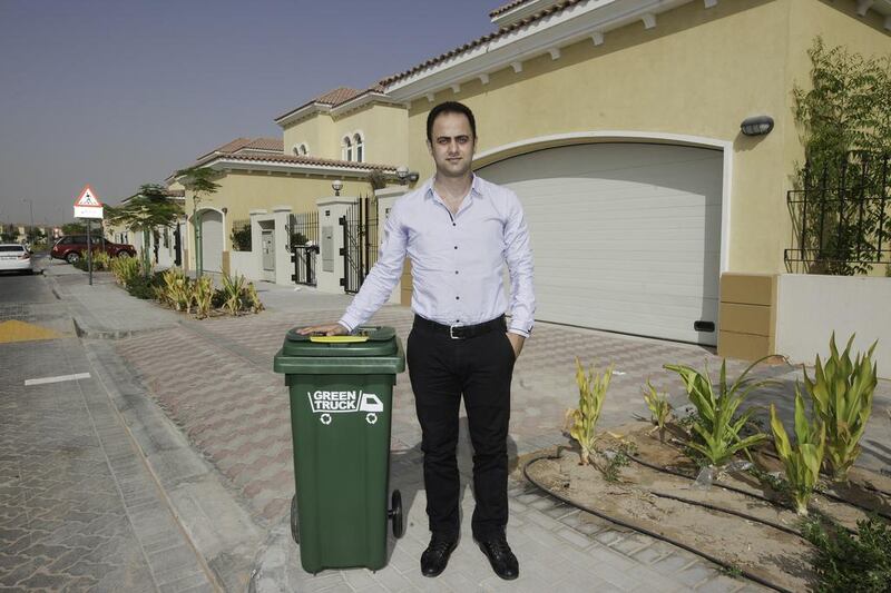 Diya Khalil with one of his Green Truck bins at Jumeirah Park.  His new company offers recycling to private villa communities.  Jaime Puebla / The National 