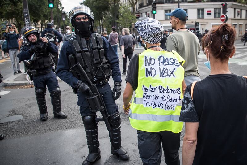 A protester wearing a yellow vest is seen at a demonstration in Paris against the French Covid-19 health pass. EPA