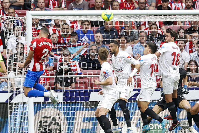 Atletico Madrid defender Jose Maria Gimenez heads home the opening goal against Sevilla. EPA