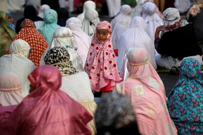 An Indonesian Muslim girl is pictured as she attends Eid al-Adha prayers on a street in Jakarta, Indonesia, August 11, 2019. REUTERS/Willy Kurniawan