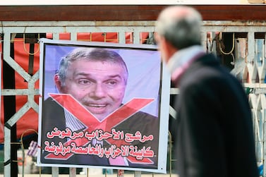A poster of Iraq's Prime Minister designate Mohammed Allawi with Arabic that reads, "The party candidate is rejected" is seen during ongoing anti-government protests in Tahrir Square, Baghdad, Iraq, Saturday, Feb. 29, 2020. AP