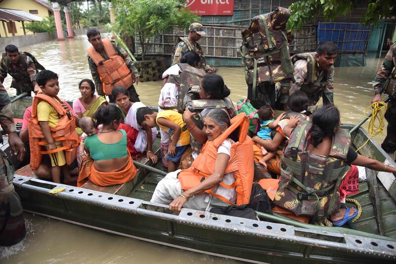 Army soldiers evacuate villagers. Biju Boro / AFP Photo