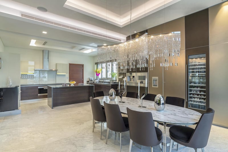 A dramatic chandelier adds some extra taste to meal times. Courtesy LuxuryProperty.com