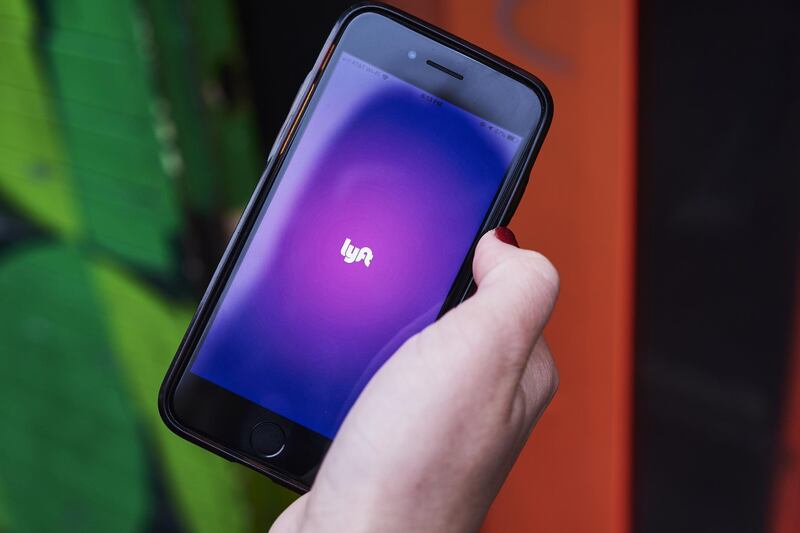 The Lyft Inc. application is displayed on an Apple Inc. iPhone in this arranged photograph taken in New York, New York, U.S., on Sunday, Feb. 24, 2019. Valued at $15.1 billion on the private markets in its last funding round, Lyft is aiming for an IPO valuation of $20 billion to $25 billion, a person familiar with the matter has said.��Photographer: Gabby Jones/Bloomberg