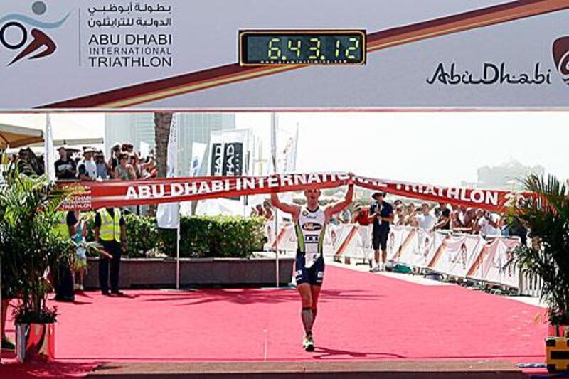 Frederik van Lierde celebrates as he crosses the line during the Abu Dhabi International Triathlon in the capital.