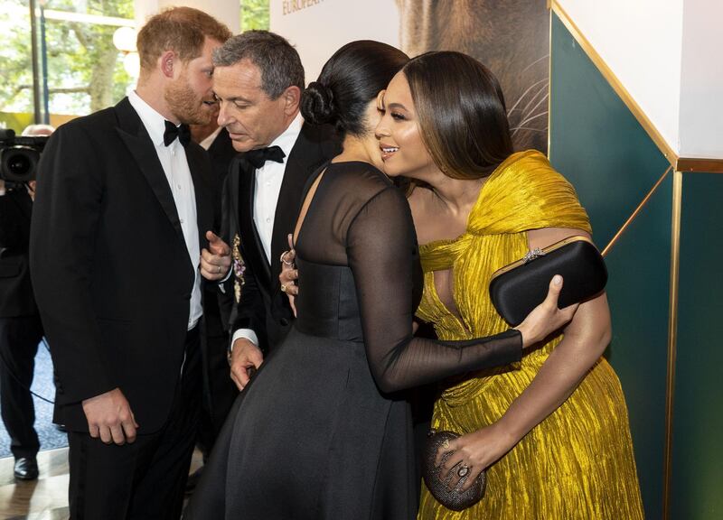 Prince Harry chats with Disney CEO Robert Iger as Meghan, Duchess of Sussex embraces Beyonce as they attend the premiere of Disney's 'The Lion King' in London's Leicester Square on July 14, 2019. AFP