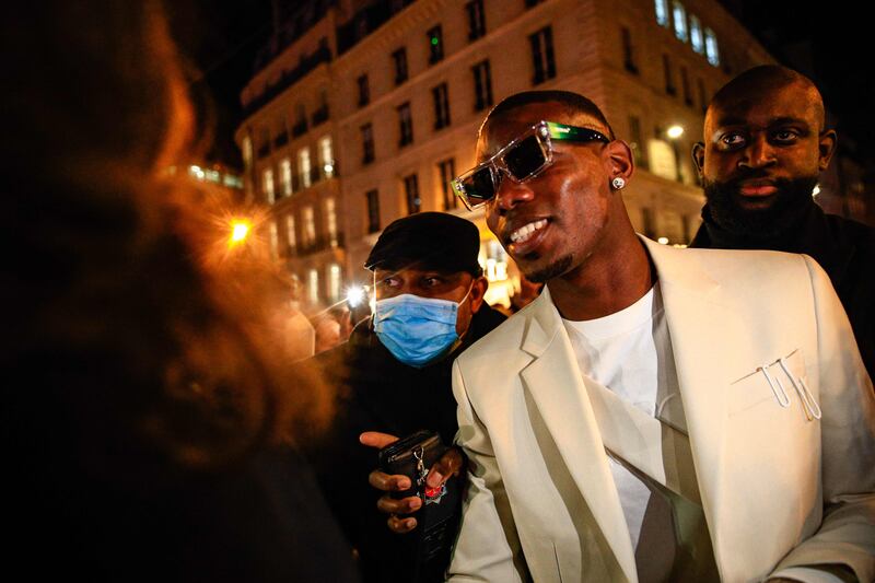 France's mdfielder Paul Pogba (C) leaves after the Women's Fall/Winter 2022/2023 Ready-to-Wear Off-White collection show during the Paris Fashion Week in Paris, on February 28, 2022.  (Photo by Sameer Al-DOUMY  /  AFP)